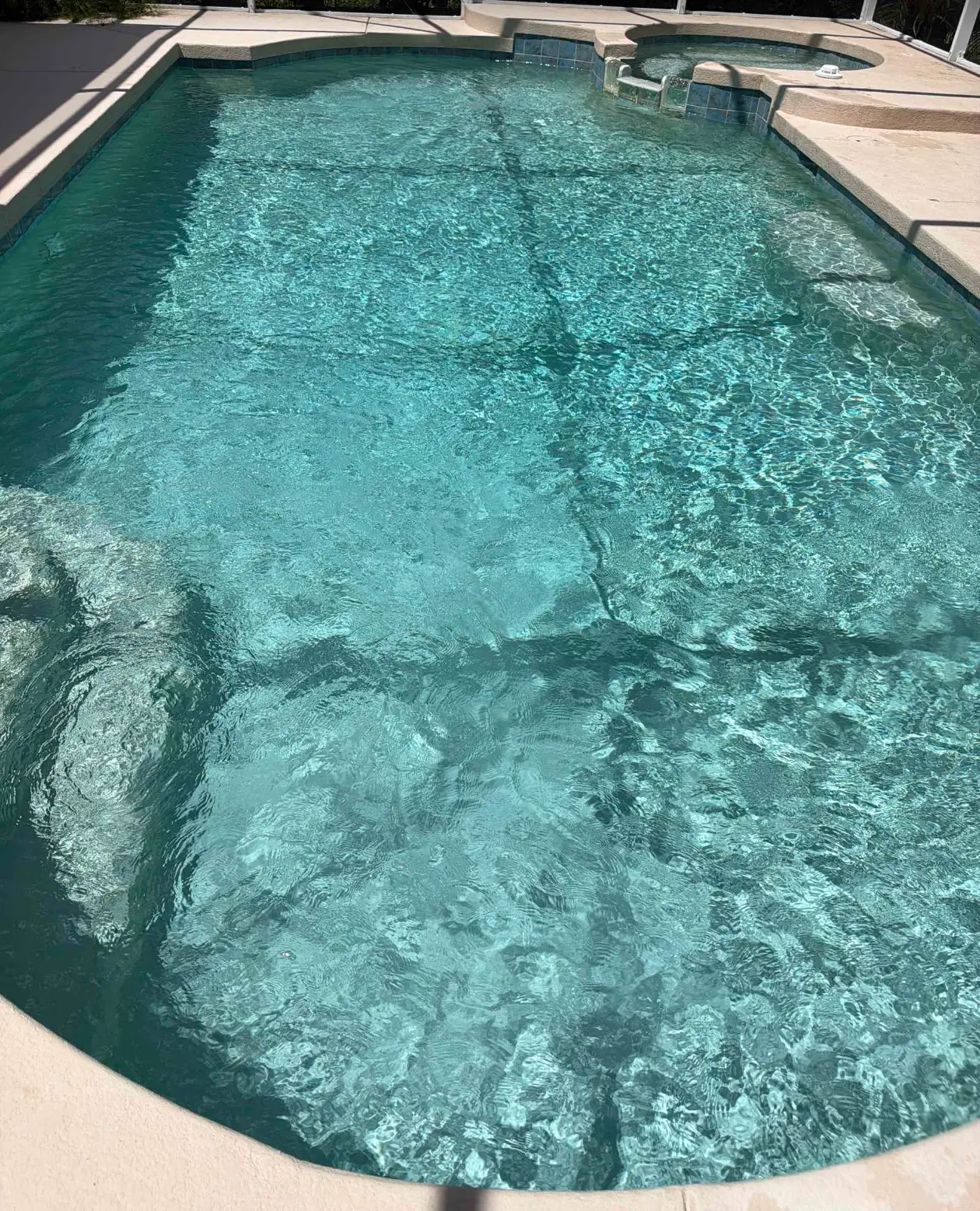 Clean pool with clear balanced water following weekly pool maintenance